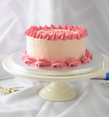 Raspberry buttercream coated cake 3" in height